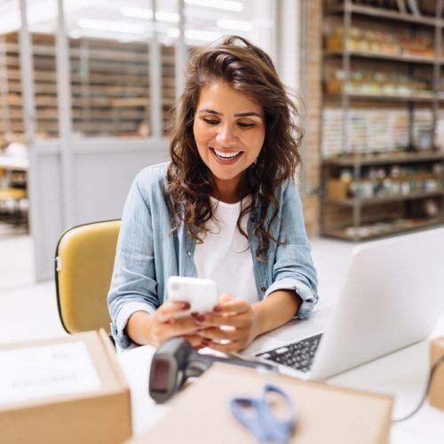 Online,Store,Owner,Reading,A,Text,Message,On,Her,Cellphone. Online,Store,Owner,Reading,A,Text,Message,On,Her,Cellphone.